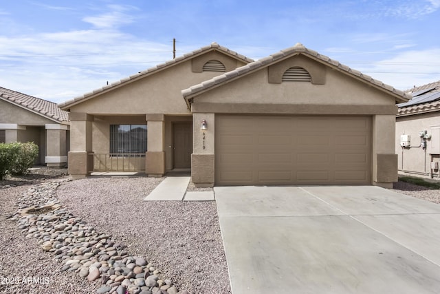 6410 W Winslow Ave, Phoenix, AZ 85043 - view of front facade with stucco siding, a garage, and driveway