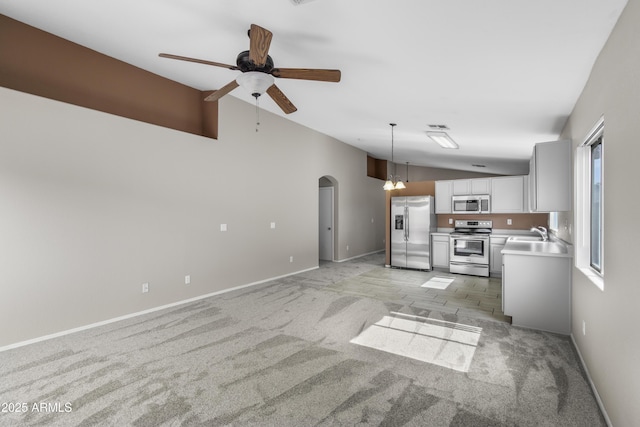 6410 W Winslow Ave, Phoenix, AZ 85043 - unfurnished living room with lofted ceiling, light carpet, a ceiling fan, arched walkways, and baseboards