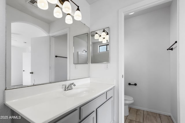 6410 W Winslow Ave, Phoenix, AZ 85043 - bathroom with vanity, toilet, and baseboards