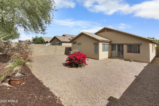 6410 W Winslow Ave, Phoenix, AZ 85043 - rear view of property with stucco siding, a fenced backyard, and a tile roof