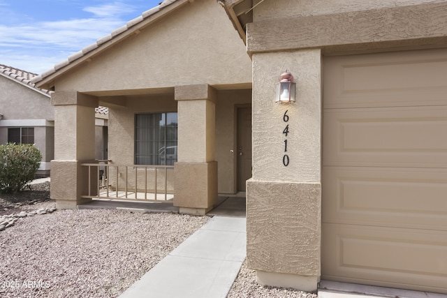 6410 W Winslow Ave, Phoenix, AZ 85043 - view of exterior entry with stucco siding and a porch