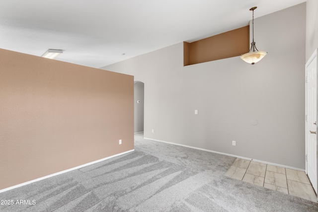 6410 W Winslow Ave, Phoenix, AZ 85043 - empty room with light carpet, baseboards, and arched walkways