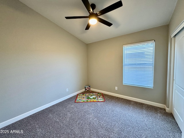 interior space featuring ceiling fan and carpet