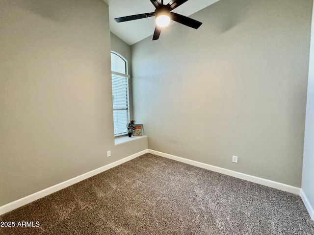 carpeted spare room with ceiling fan and vaulted ceiling