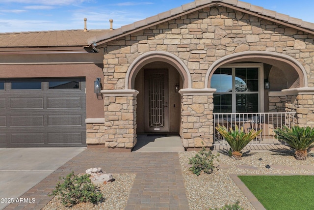 entrance to property with a garage and covered porch