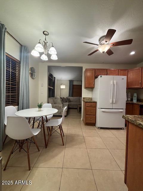 1940 E Indianola Ave E, Phoenix, AZ 85016 - dining space featuring a ceiling fan, light tile patterned floors, and a chandelier