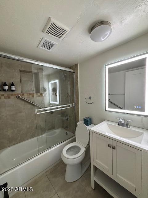 1940 E Indianola Ave E, Phoenix, AZ 85016 - bathroom featuring tile patterned floors, vanity, and shower / bath combination with glass door