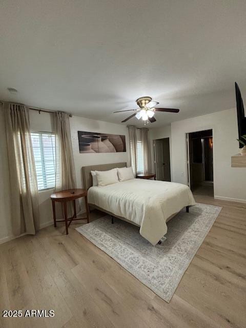 1940 E Indianola Ave E, Phoenix, AZ 85016 - bedroom with light wood-style floors and a ceiling fan