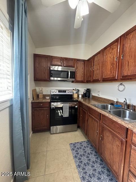 1940 E Indianola Ave E, Phoenix, AZ 85016 - kitchen with appliances with stainless steel finishes, light tile patterned floors, lofted ceiling, and ceiling fan