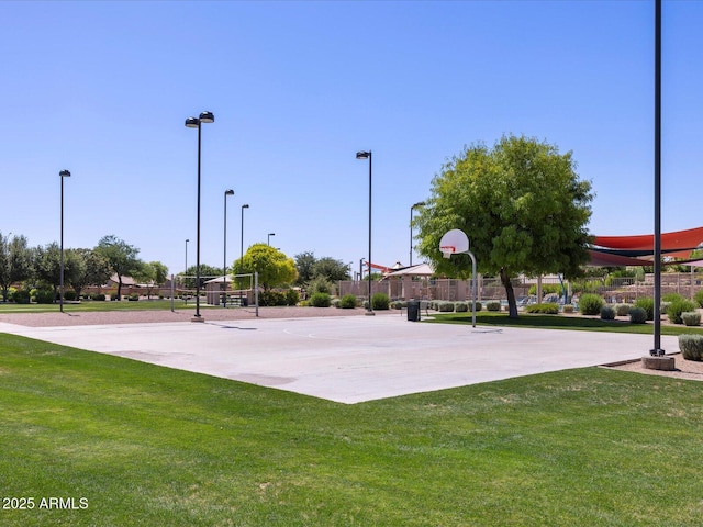 view of basketball court with a yard