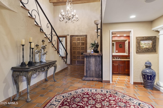 entrance foyer featuring sink and an inviting chandelier