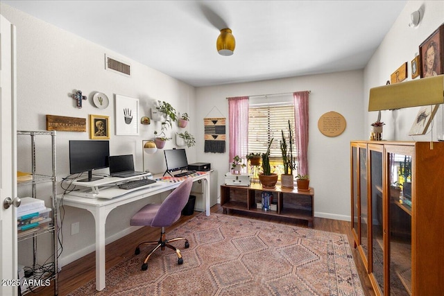 office with wood finished floors, visible vents, and baseboards