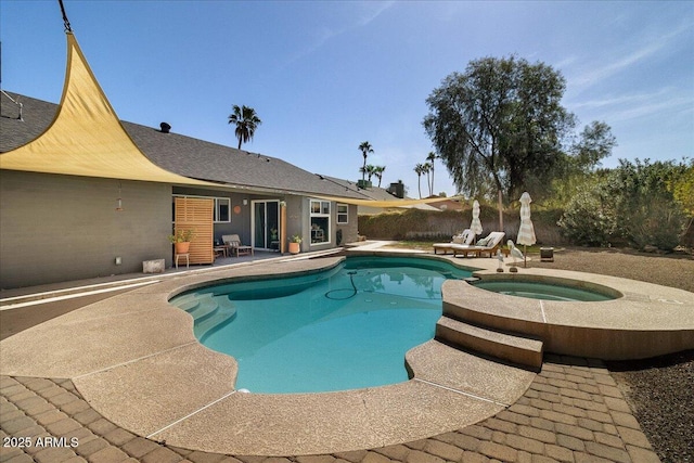 view of swimming pool with a pool with connected hot tub, a patio, and fence