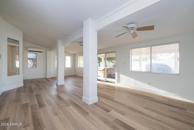 3956 N 151st Dr, Goodyear, AZ 85395 - empty room featuring a ceiling fan, vaulted ceiling, a wall mounted AC, and light wood finished floors