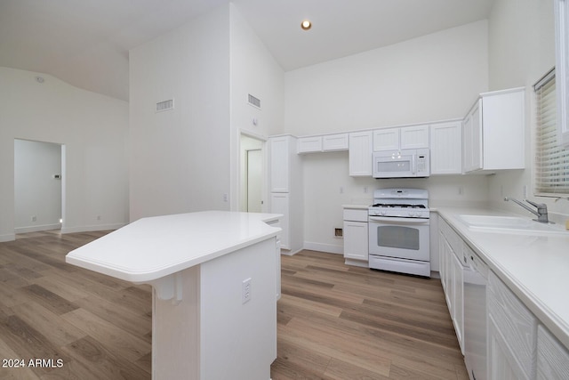 3956 N 151st Dr, Goodyear, AZ 85395 - kitchen featuring white appliances, high vaulted ceiling, white cabinets, light wood-type flooring, and light countertops