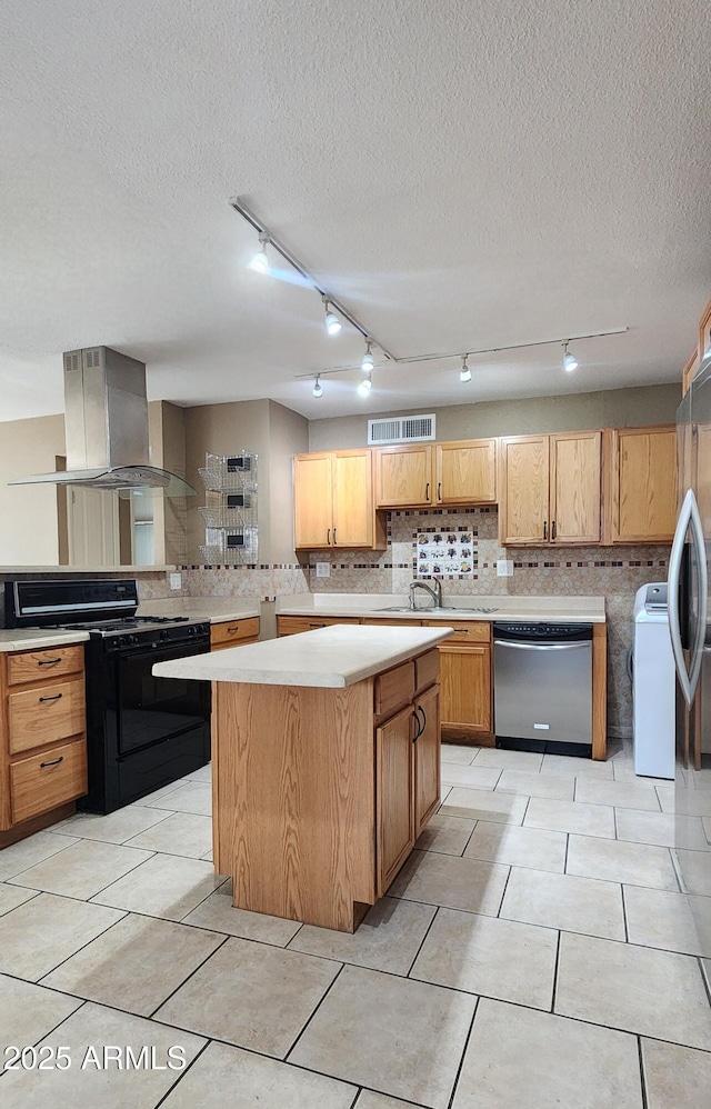 kitchen featuring visible vents, light countertops, appliances with stainless steel finishes, a center island, and island exhaust hood