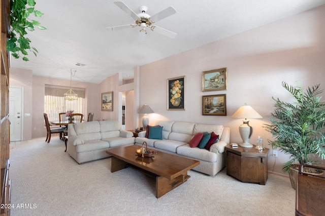 carpeted living room with ceiling fan with notable chandelier