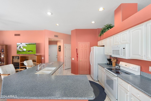 kitchen featuring light tile patterned floors, white cabinets, sink, and white appliances