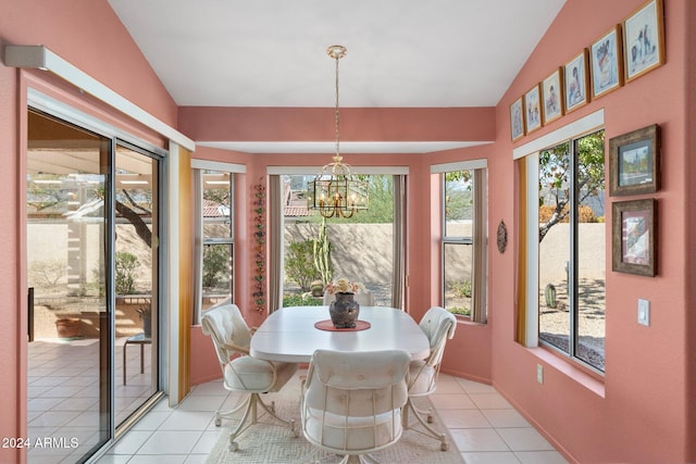 sunroom / solarium with lofted ceiling, plenty of natural light, and a chandelier