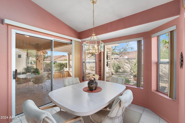 dining area with light tile patterned flooring, plenty of natural light, and vaulted ceiling