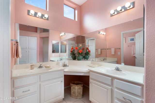 bathroom featuring vanity, a towering ceiling, and tile patterned flooring