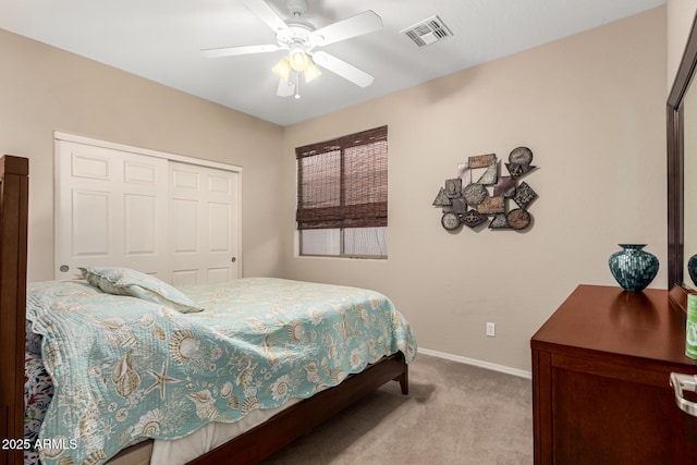 carpeted bedroom featuring ceiling fan, a closet, visible vents, and baseboards