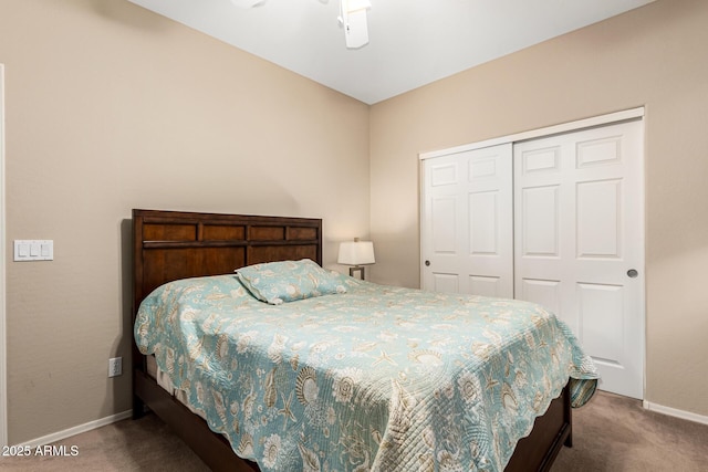 carpeted bedroom featuring a closet and baseboards