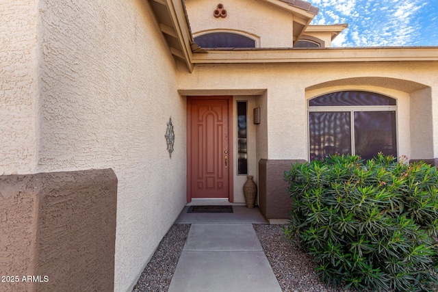 property entrance with stucco siding