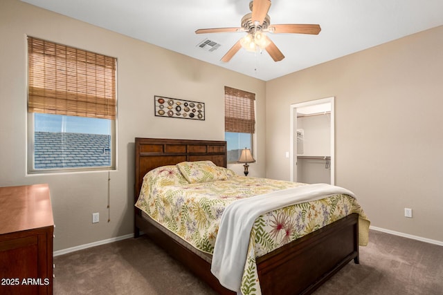 carpeted bedroom featuring a spacious closet, a ceiling fan, visible vents, and baseboards