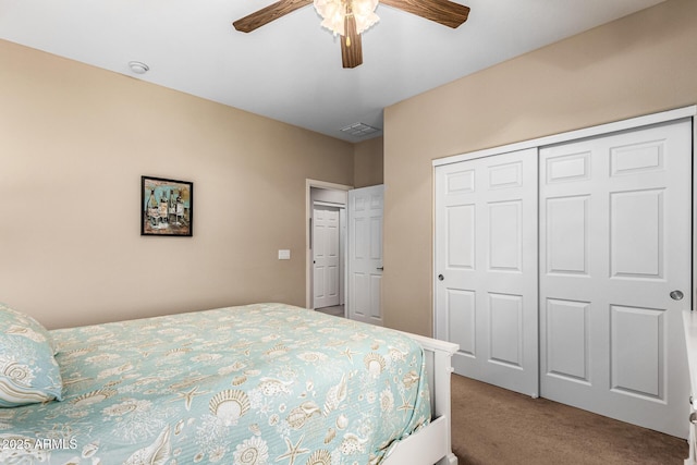 bedroom featuring carpet floors, a closet, visible vents, and a ceiling fan