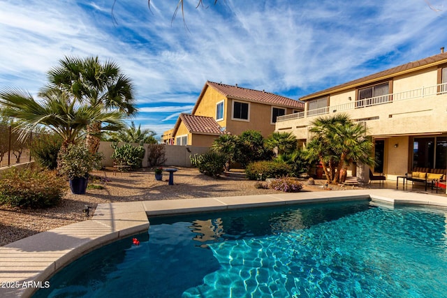 outdoor pool with a patio area and fence