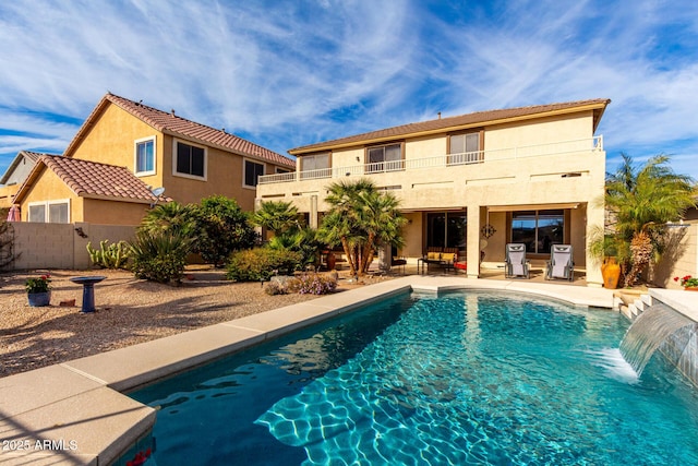 outdoor pool with a patio area and fence