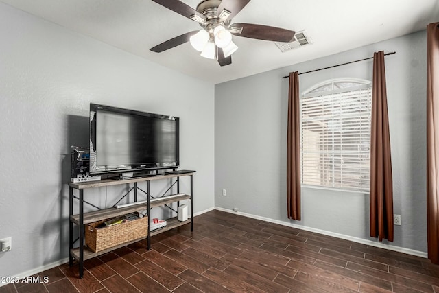 interior space with a ceiling fan, wood finish floors, visible vents, and baseboards