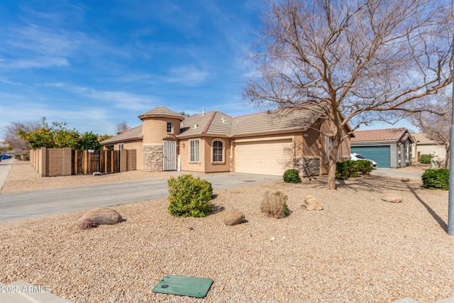 view of front of home featuring stone siding, a tile roof, driveway, and stucco siding