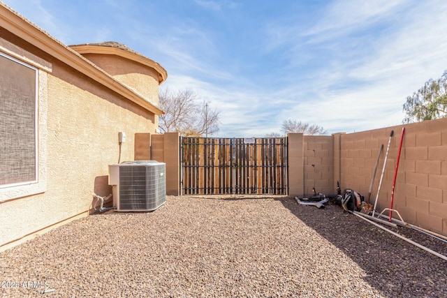 view of yard with central AC unit and a fenced backyard