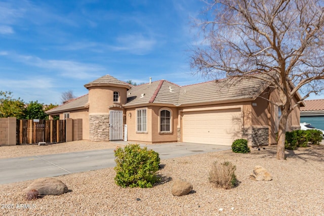 ranch-style house featuring a garage, fence, stone siding, concrete driveway, and stucco siding