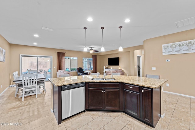 kitchen featuring hanging light fixtures, dishwasher, a kitchen island with sink, and sink