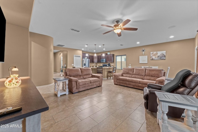 living room with light tile patterned floors and ceiling fan