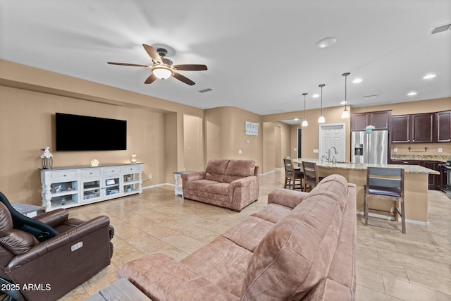 living room featuring sink and ceiling fan