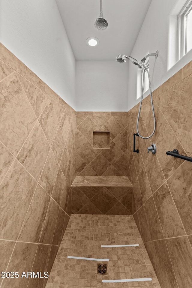 bathroom with tiled shower