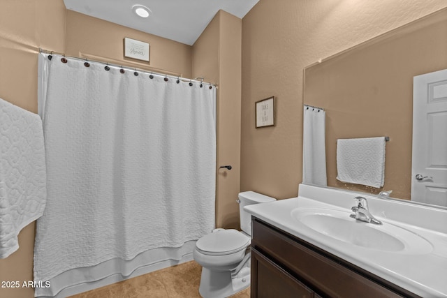 bathroom with vanity, tile patterned floors, and toilet