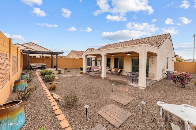 rear view of property with ceiling fan, outdoor lounge area, a pergola, and a patio