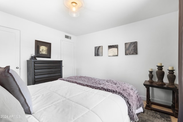 bedroom with hardwood / wood-style flooring