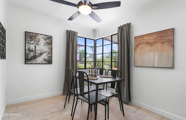 dining room featuring ornamental molding, light wood-type flooring, and ceiling fan