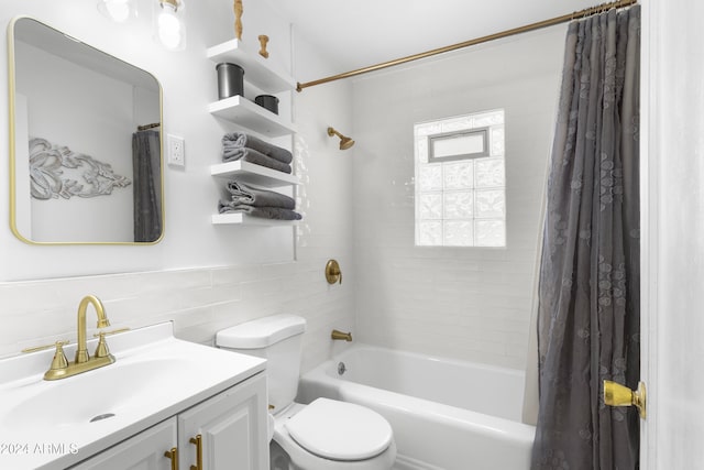 full bathroom with toilet, shower / bath combo with shower curtain, vanity, and tile walls