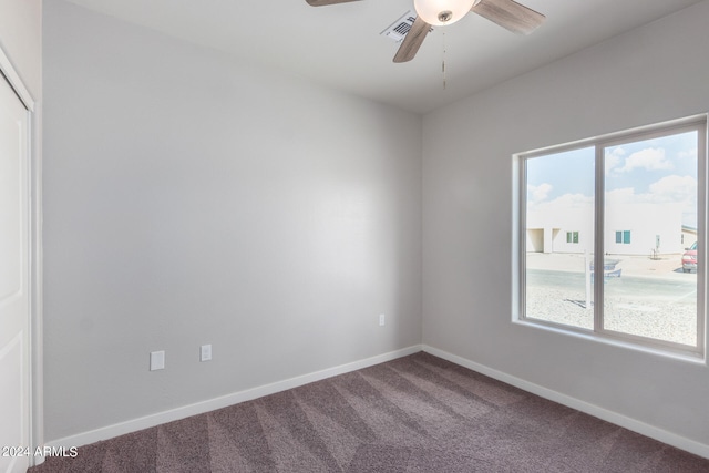 carpeted empty room featuring ceiling fan