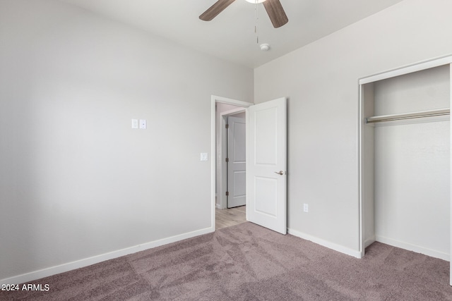 unfurnished bedroom featuring light carpet, ceiling fan, and a closet