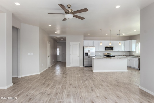 kitchen with stainless steel appliances, a center island, light hardwood / wood-style flooring, ceiling fan, and decorative light fixtures