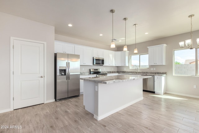 kitchen with light hardwood / wood-style flooring, stainless steel appliances, and white cabinetry