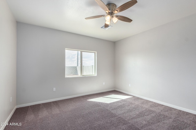 carpeted empty room featuring ceiling fan